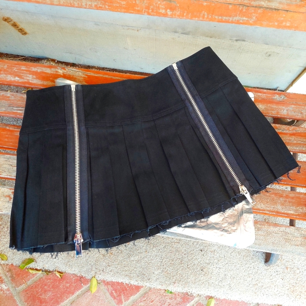 DollsKill Mini pleated skirt with adjustable zippers.